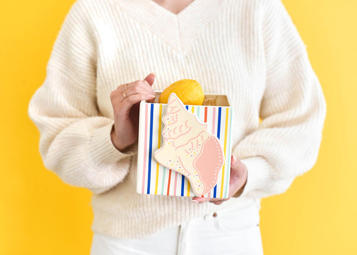 Woman Holding Mini Nesting Cube with Mini Attachment Conch  Shell Design